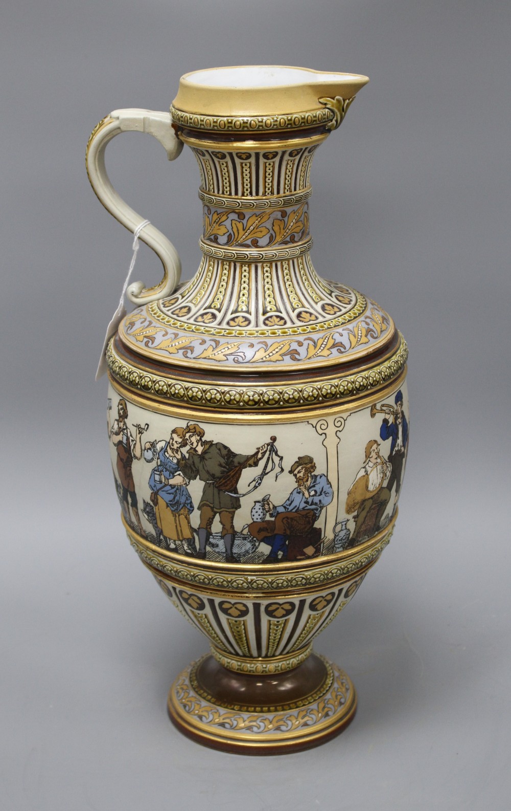 A large Villeroy and Boch Mettlach ewer, decorated with figures drinking, dancing and musicians, impressed 1159, height 45cm